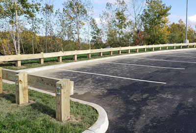 Timber guardrail installation in parking lot