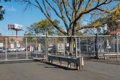 Security fence with "Do Not Enter" sign attached installed near parking lot