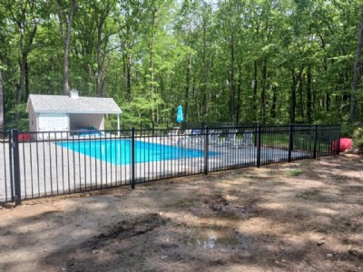 Aluminum fence installed outside of in-ground pool.