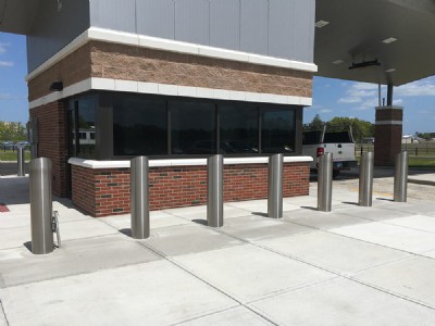 Galvanized security bollards on cement walkway