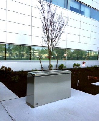 Wide, galvanized security barrier on walkway outside of office building