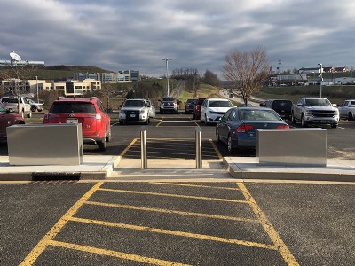 Two security bollard posts between two wider barriers