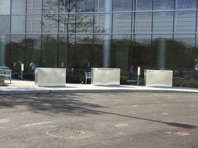 Wide, galvanized security barriers outside of office building