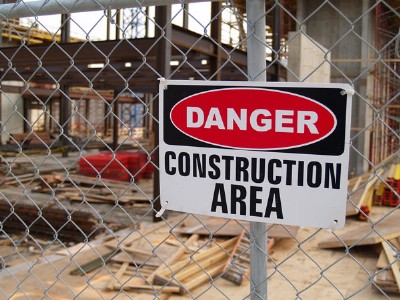 Temporary fence rental with a sign attached that reads "Danger: Construction Area"