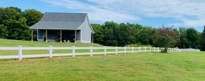 White vinyl fencing installation in yard