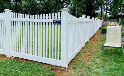 White vinyl fencing installation in yard