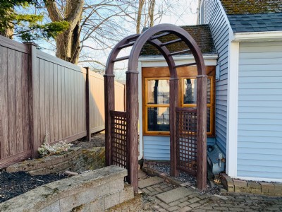 brown vinyl fence installation in backyard