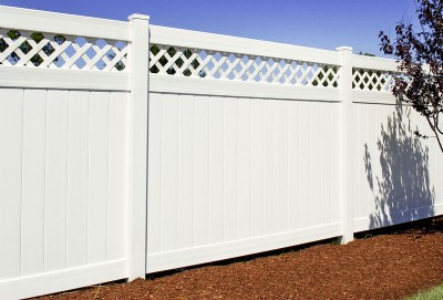 White vinyl fence installation in yard