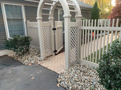 White vinyl fence installation near house