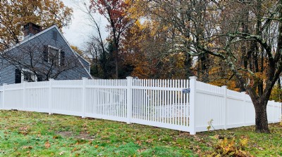 White vinyl fence installation in yard