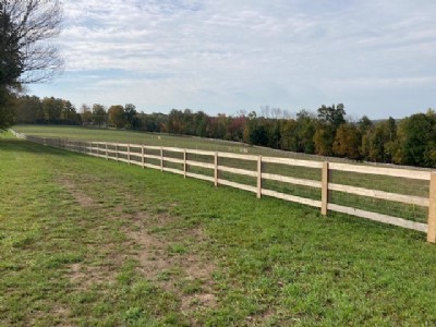 Long cedar wood fencing in grass